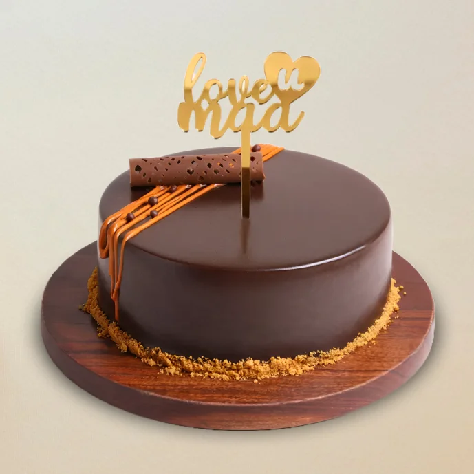 Glossy chocolate Mother’s Day cake with “Love You Maa” topper and decorative swirl