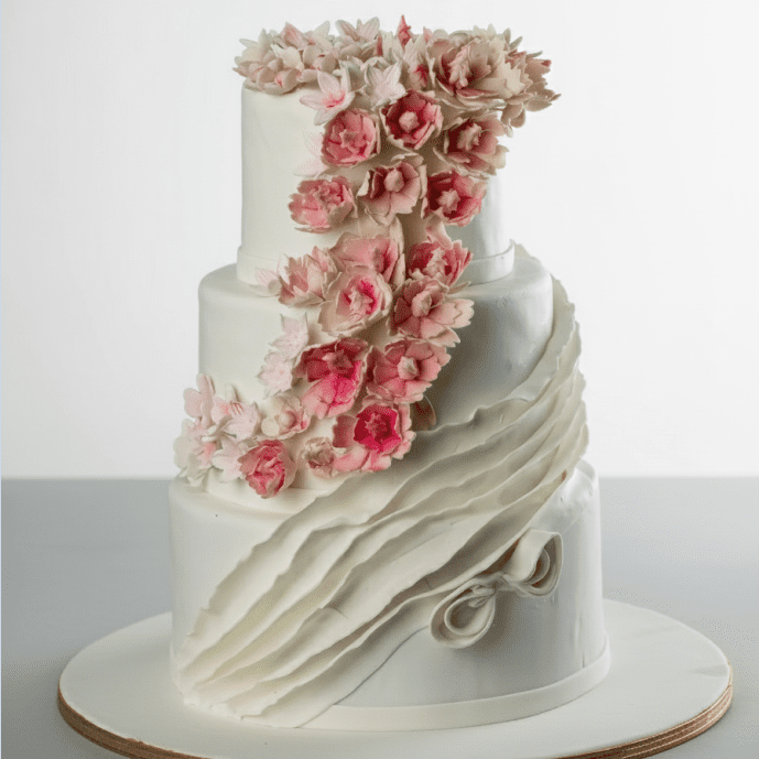 three tier white wedding cake with flowers