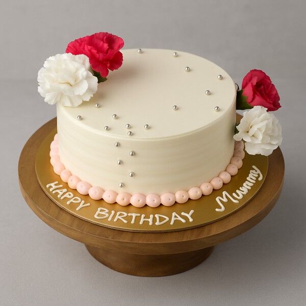 Birthday cake decorated with pink and white flowers
