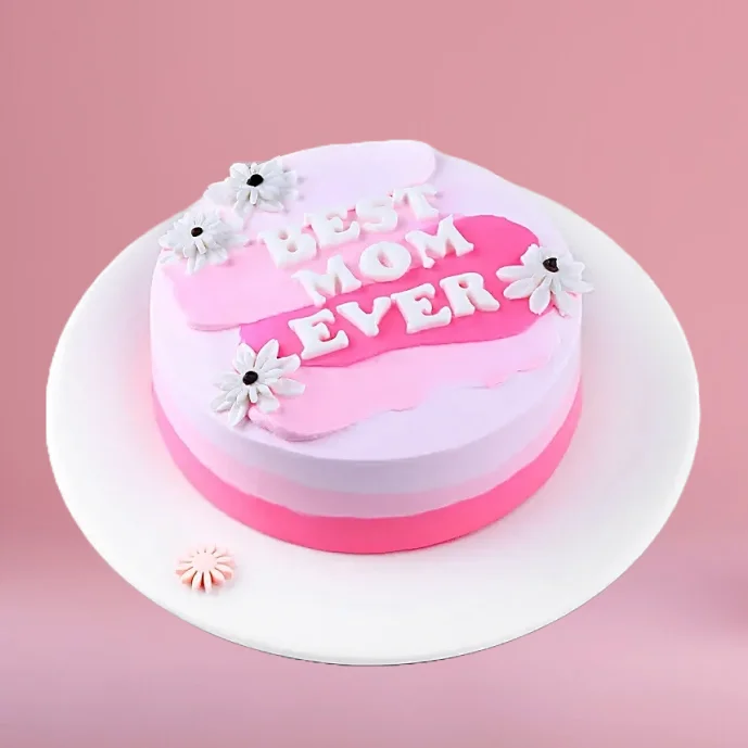 Pink ombre Mother’s Day cake with “Best Mom Ever” message and white flower decorations