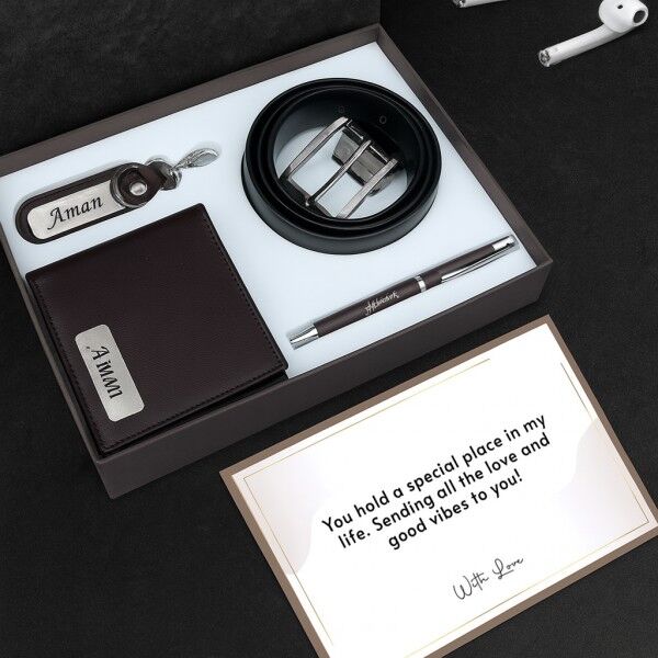 A gift box with wallet, belt, pen, and keychain