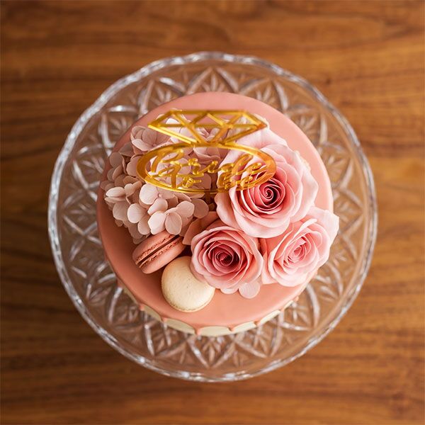 bride to be drip cake with floral topper top view