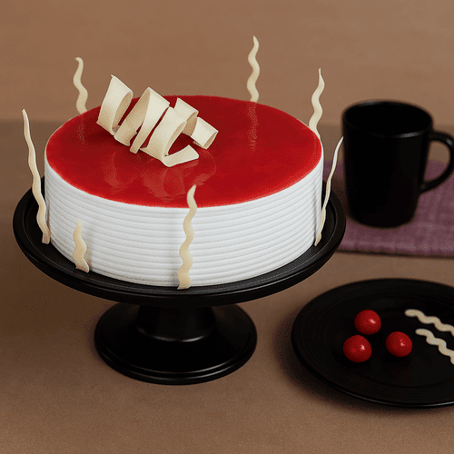 Red glaze cake with white chocolate decor on stand