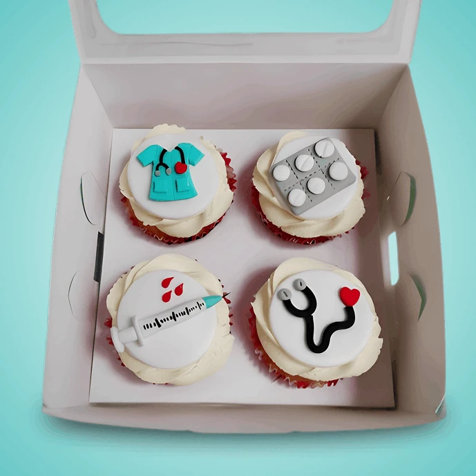 Set of four medical-themed cupcakes with stethoscope, heartbeat, ambulance, and first-aid kit.