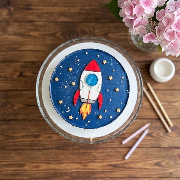 galaxy rocket cake with gold stars top view