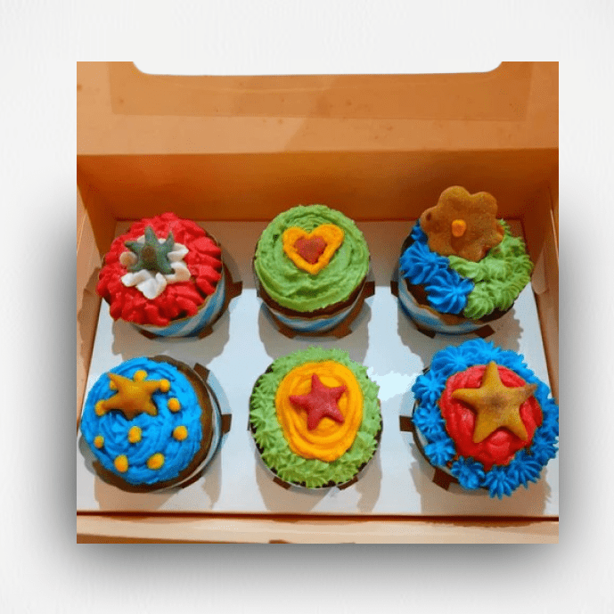 Box of colorful star-decorated cupcakes for dogs