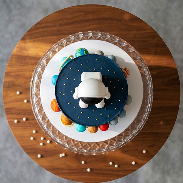 solar system galaxy cake with astronaut top view
