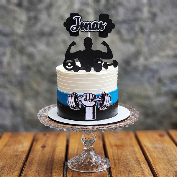 White, blue, and black striped cake with weightlifter silhouette and custom name topper.
