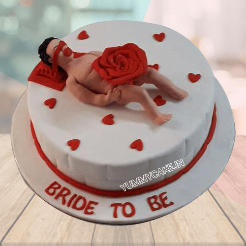 man on the top of the cake with Bride to be cake message