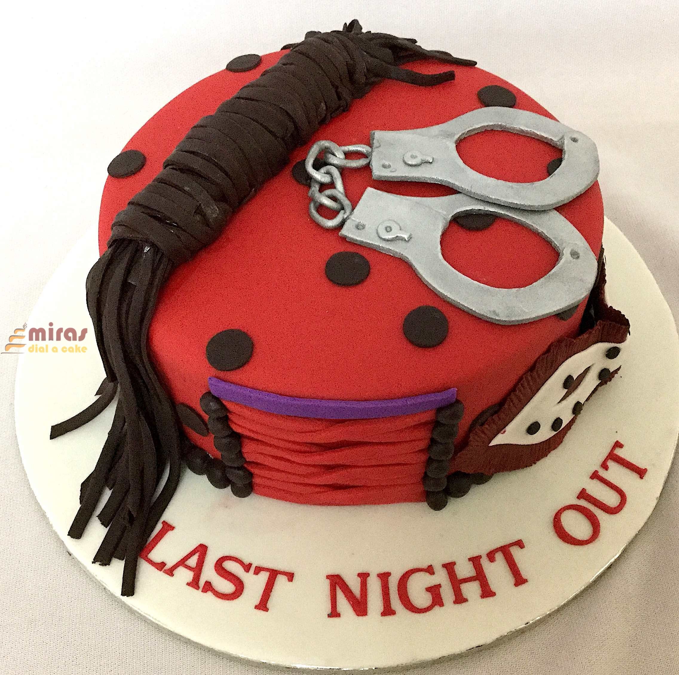 A ladybug cake with handcuffs on it